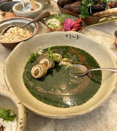 a bowl filled with soup next to other dishes