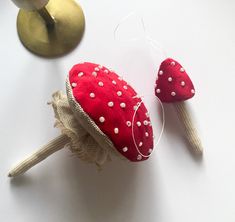 two red and white polka dot covered candy lollipops sitting next to each other