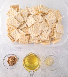 crackers, olive oil and seasoning in bowls