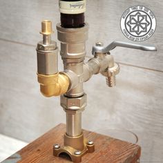 a faucet made out of metal pipes on top of a wooden table