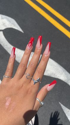 bright red acrylic nails with a V-shaped french tip and a fire design on my ring finger. French Tip Nails With Fire Design, Red Coffin French Tip, Red V Tip Acrylic Nails, Red V Tip Nails Coffin, V Shaped French Tip Nails Coffin, Bright Red Acrylic Nails Designs, Fire French Tip Nails, Fire Acrylic Nails, Red V French Tip Nails Coffin