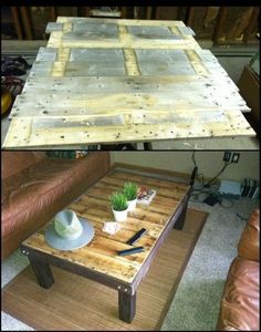 a coffee table made out of pallet wood with a plant on top and another side