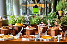 a buffet table filled with lots of food and utensils on top of it