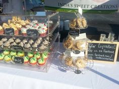 cupcakes and muffins are on display for sale