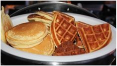 a white plate topped with pancakes and waffles