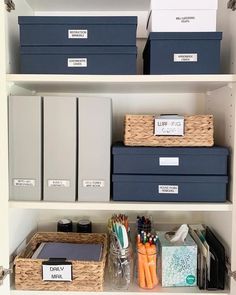 the shelves are organized with boxes, pens and other office supplies on them for organization