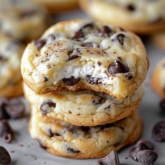 three cookies with chocolate chips and white frosting