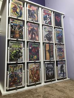 a display case with comic books on it in a room filled with carpeted walls