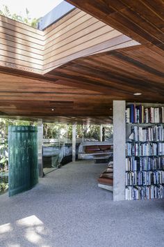 the inside of a building with bookshelves and benches