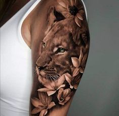 a woman's arm with a lion and flowers on it