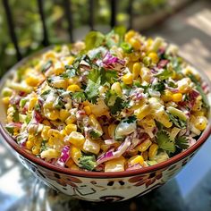 a bowl filled with corn salad on top of a table