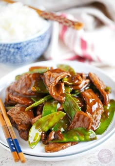 a white plate topped with beef and peppers