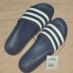 Adilwtte Aqua Sandals Casual Blue Flip Flops With Cushioned Footbed, Adidas Blue Sandals For Spring, Casual Adidas Flip Flops For Spring, Adidas Casual Synthetic Sandals, Navy Cushioned Slides For Summer, Navy Slides With Cushioned Footbed For Summer, Adidas Casual Flat Sandals, Adidas Cushioned Round Toe Flip Flops, Adidas Casual Slip-on Sandals