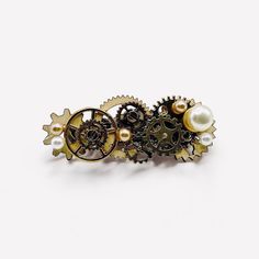 Sphider Design Handmade Gold Cog and Pearl Hair Clip ⚙️ Add a touch of industrial elegance to your hairstyle with this unique hair clip. ⚙️ Inspired by the steampunk aesthetic, this hair clip features intricate gold gears adorned with delicate pearls. The perfect blend of vintage and modern elements creates a truly one-of-a-kind piece. ⚙️ Only one available as I like to make a unique, standout, rare, special piece that you can't find anywhere else. Care Instructions: Keep your hairclips away fro Unique Hair Clip, Steampunk Aesthetic, Alt Grunge, Unique Hair, Modern Elements, Pearl Hair Clip, Your Hairstyle, Pearl Hair, Victorian Gothic