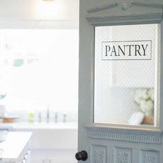 the pantry door is open to reveal an empty kitchen