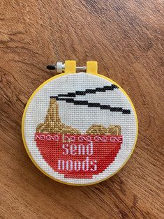 a cross - stitch hoop hanging on a wooden surface with the words once upon it