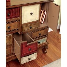 an old dresser with many drawers on it's sides and one open drawer in the middle