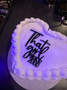 a cake with the words that go on it is lit up in purple and black