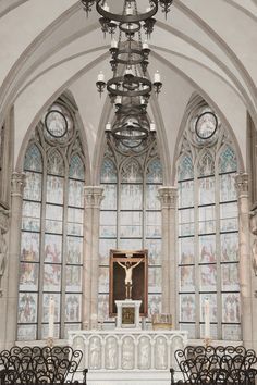 the interior of a church with pews and stained glass windows