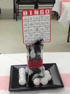 a black plate topped with white balls and a sign that says bingo on it