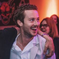 a smiling man and woman sitting next to each other