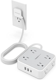 an electrical outlet plugged in to a white wall charger with two cords attached