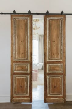 an open wooden door in a white room