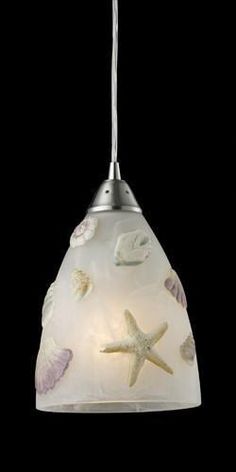 a light fixture with shells and starfishs on it