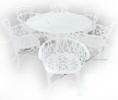 a white table and six chairs sitting next to each other