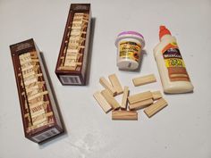 several pieces of wood sitting on top of a table next to glue and wooden pegs