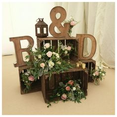 the wooden letters are decorated with flowers and candles