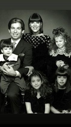 a family posing for a black and white photo