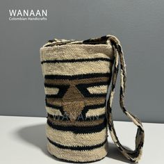 the small bag is made out of jute and has a black stripe pattern on it