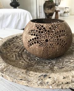 a vase sitting on top of a wooden table