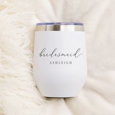 the bridesmaid stemless wine tumbler is sitting on a white blanket