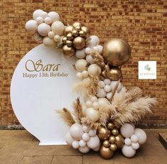 balloons and decorations on display in front of a brick wall