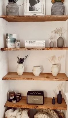 some shelves with baskets and pictures on them