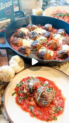 two pans filled with meatballs and sauce on top of a table next to garlic