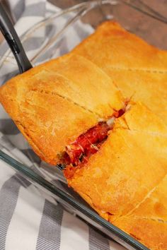 a close up of a sandwich in a glass dish