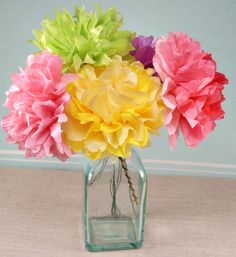 a vase filled with colorful flowers on top of a table