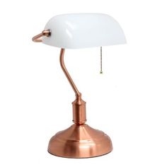 a white and copper desk lamp on a white background