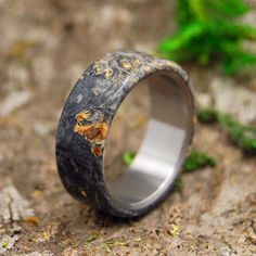 a wedding ring made out of antler wood and silver plated with gold flecks