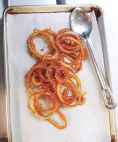 some food is laying on a tray with a spoon