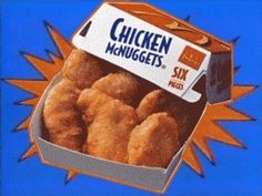 an advertisement for chicken nuggets in a box on a blue and orange background