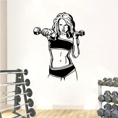 a wall decal with a woman holding two dumbbells