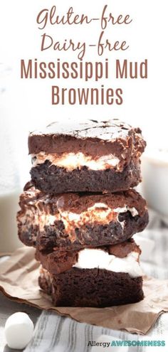 three brownies stacked on top of each other with marshmallows next to them