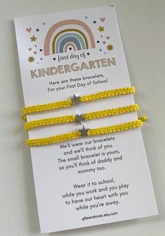 two yellow bracelets with silver stars and rainbow in the background that says, just day of kindergarten here are three bracelets for your first day school