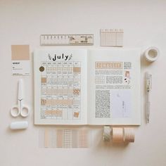 the contents of a planner spread out on a table with scissors, tape and other items