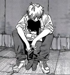 an anime character sitting on the ground with his head in his hands and looking down