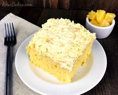 a piece of cake sitting on top of a white plate next to a fork and knife